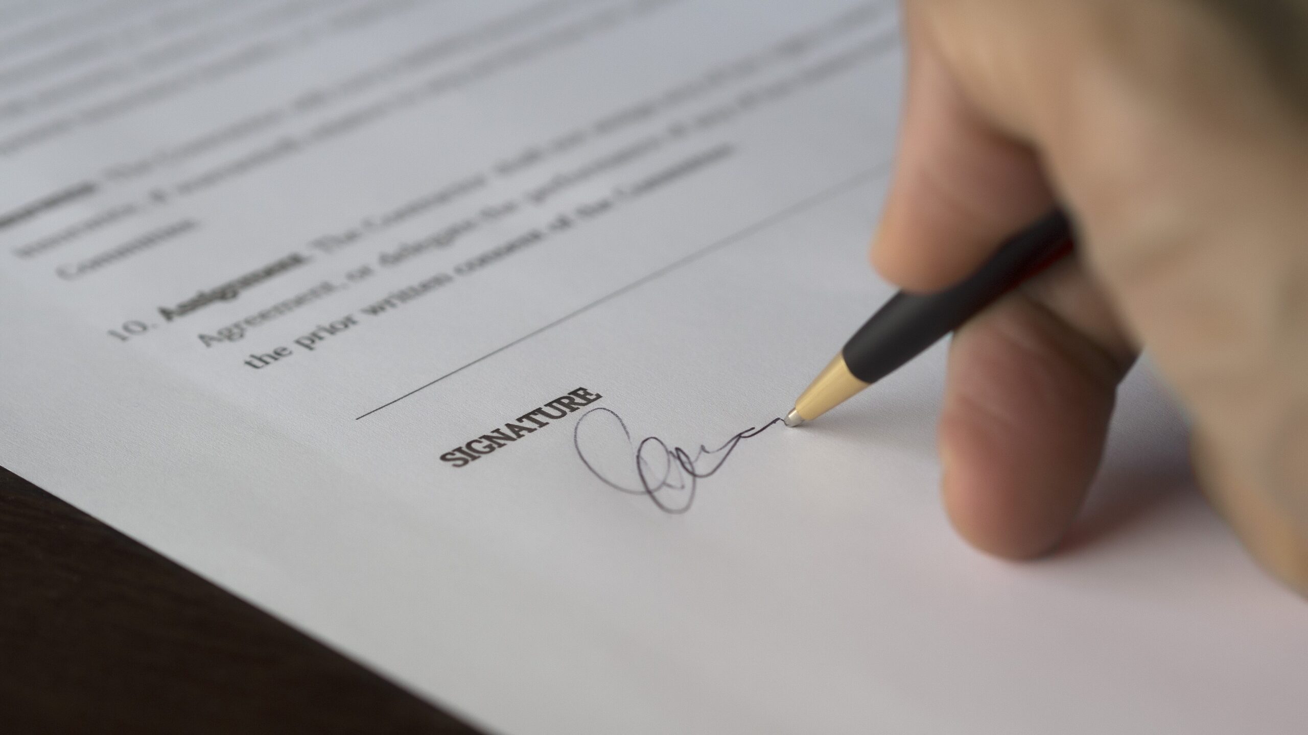 Hand signing an agreement